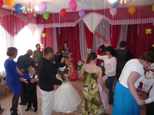 Дети танцуют с родителями под приятную мелодию